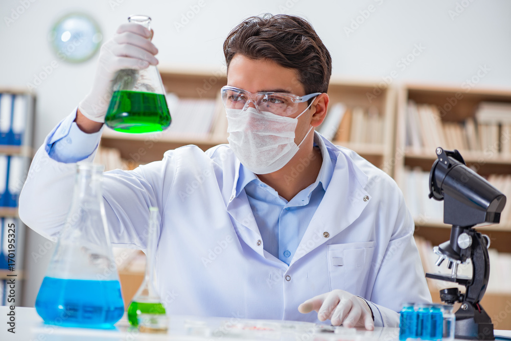 Male doctor working in the lab on virus vaccine Male doctor working in the lab on virus vaccine