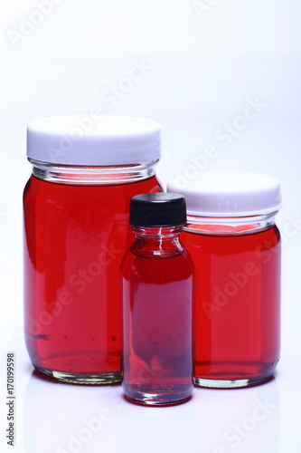 Red Liquid in Glass Bottle white cap