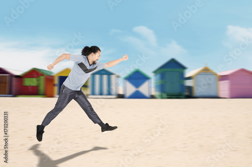 African man running at coast