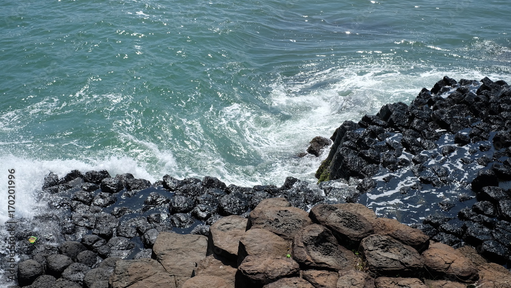 The Sea cliff of Stone Plates in Phu Yen province, Vietnam. A seashore area of uniformly basalt rock created from volcanic eruptions millions of years ago. The rocks are dark lava columns.