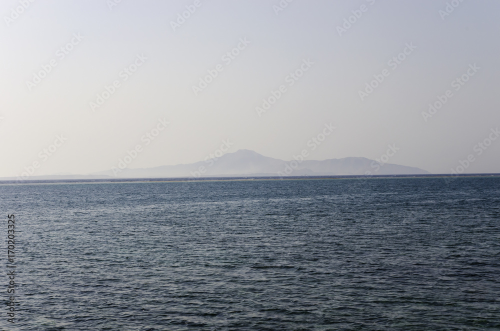 Tiran Island on the horizon in the Red Sea