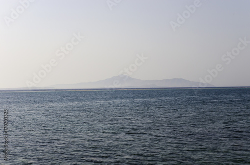 Tiran Island on the horizon in the Red Sea