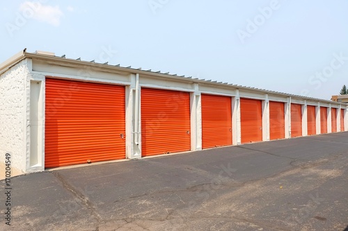 Row of an orange metal doors of a public storage