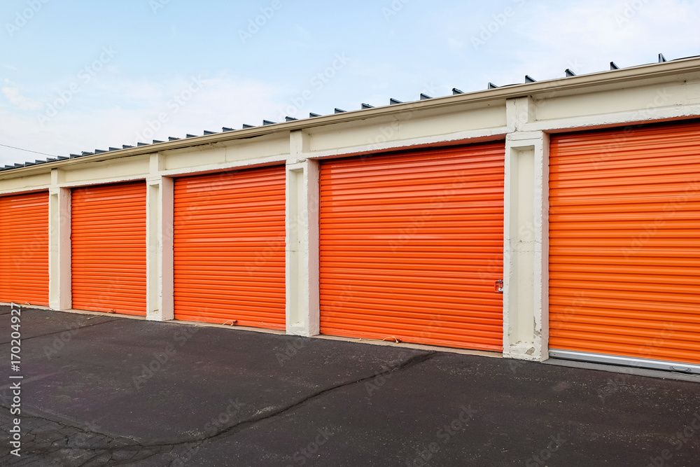 Row of an orange metal doors of a public storage