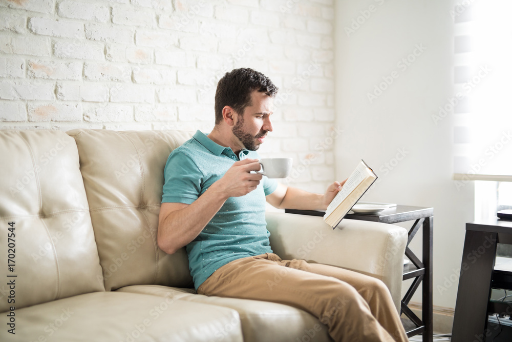 Attractive man reading his favorite novel