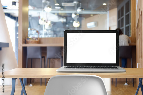 Mock up Blank screen of Laptop on marble table in Co-working or cafe. © bongkarn