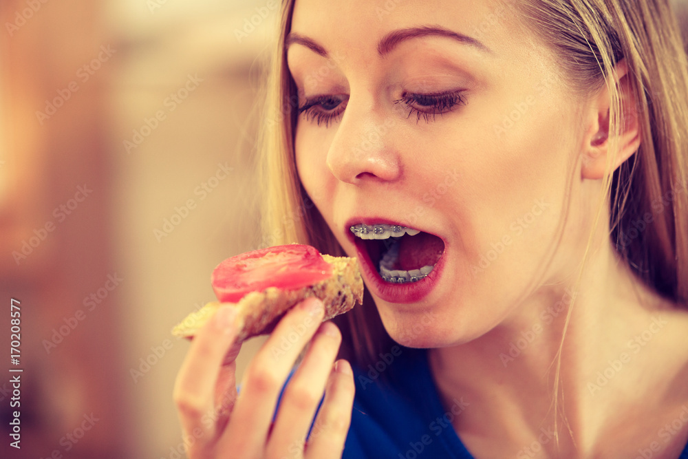 Woman having healthy breakfast eating sandwich Woman having healthy breakfast eating sandwich