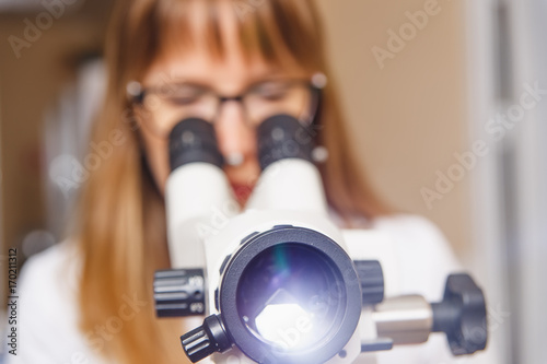 woman gynecologist working with colposcope photo