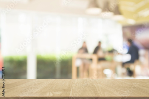 Wood table top and blurred restaurant interior background - can used for display or montage your products.
