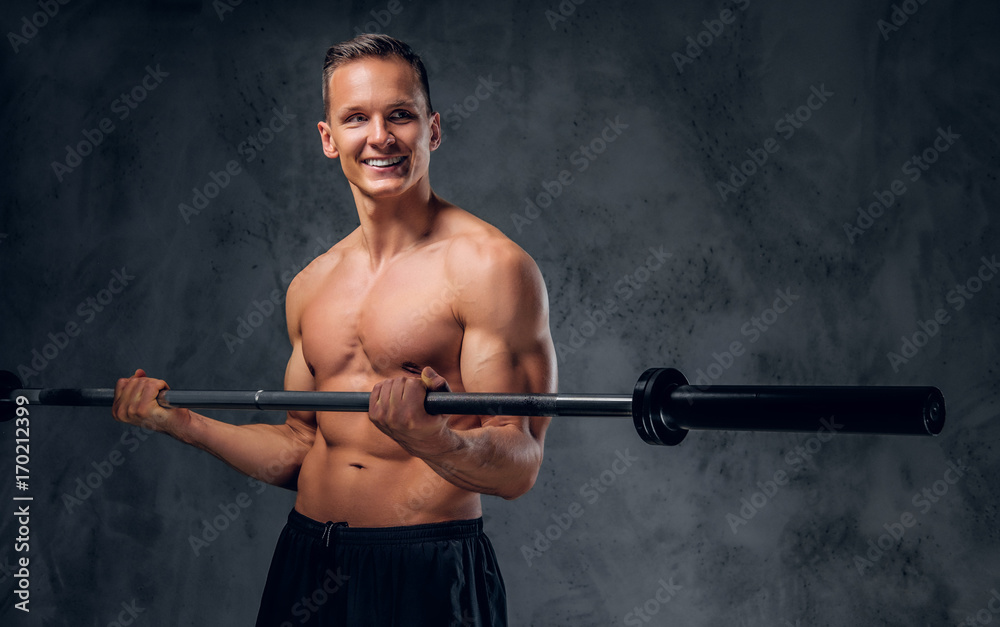 Shirtless male holds barbell. Shirtless male holds barbell.