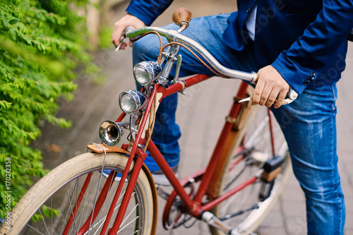 Close up image of a man on a retro bicycle.