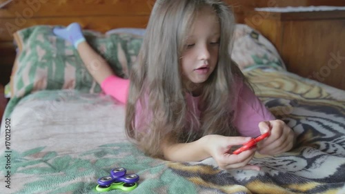 Little girl playing with spinner.