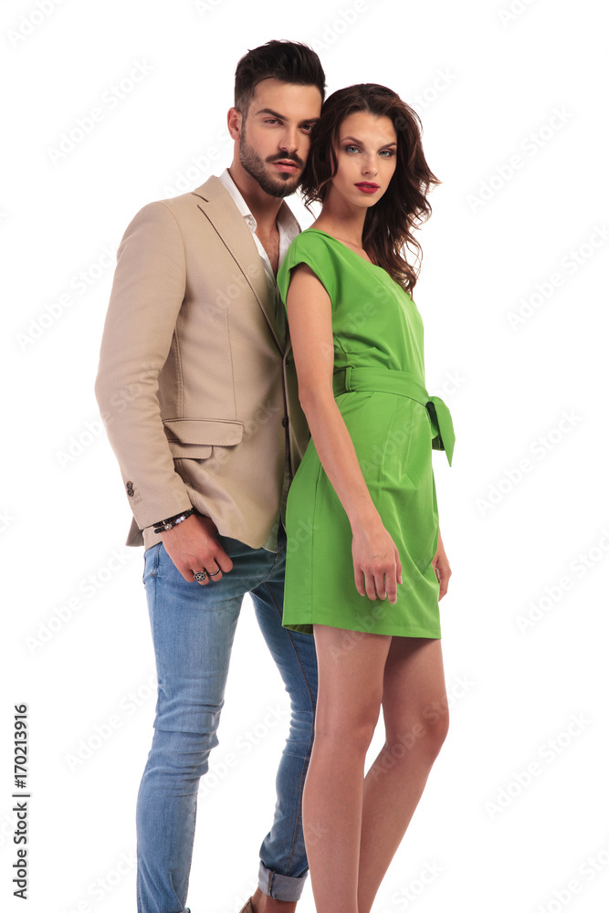 young modern couple standing together on white background young modern couple standing together on white background