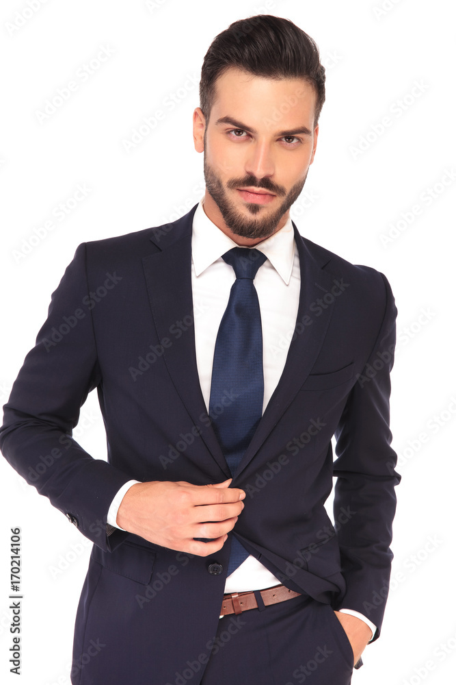 portrait of a young confident business man closing his suit portrait of a young confident business man closing his suit