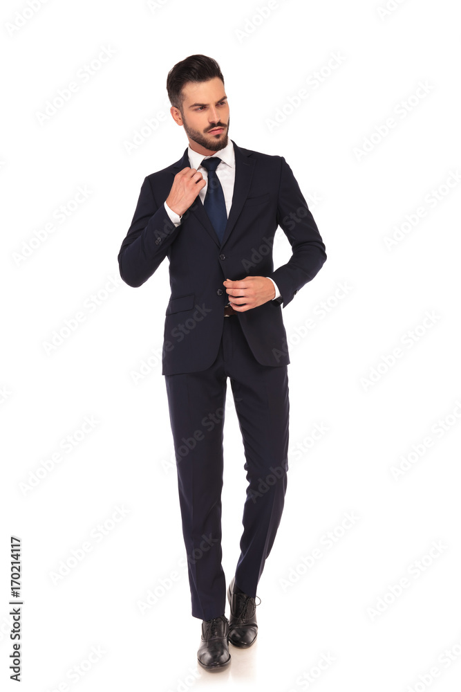 fashion young business man fixing his coat and collar fashion young business man fixing his coat and collar
