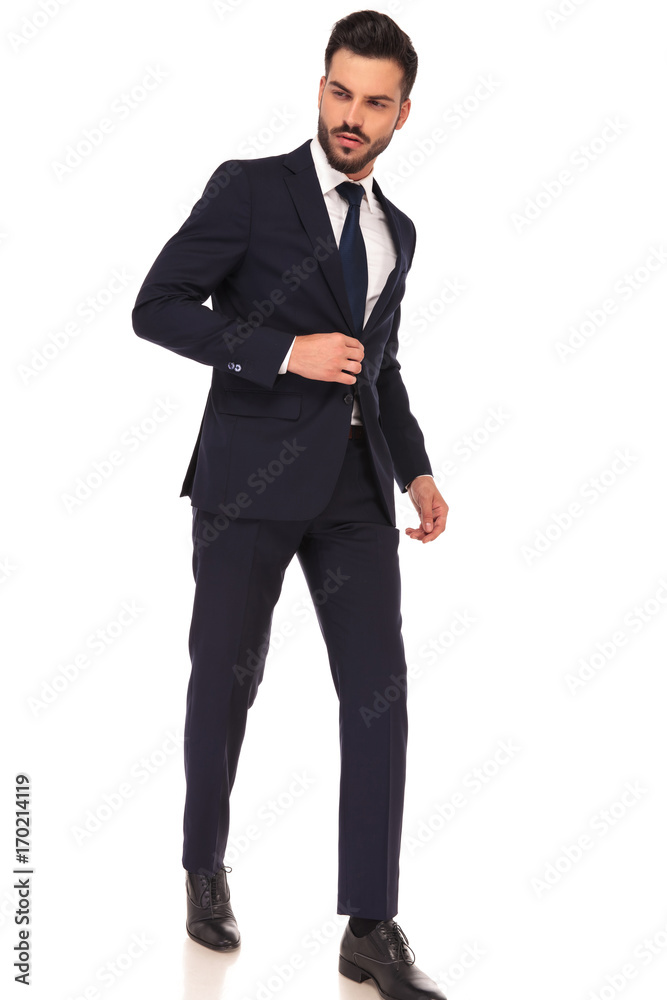 side view of a walking young business man looking away side view of a walking young business man looking away