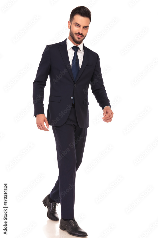 side view of a modern smiling business man walking side view of a modern smiling business man walking
