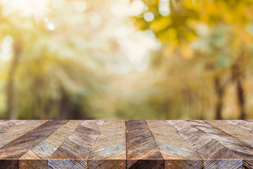 Empty old rustic wood plank table top with blur forest tree with sunlight,Autumn fall backgorund,Mock up for display or montage of product,banner for advertise on online.