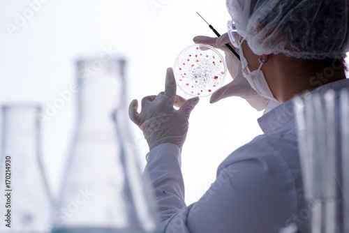 Female scientist researcher conducting an experiment in a labora photo