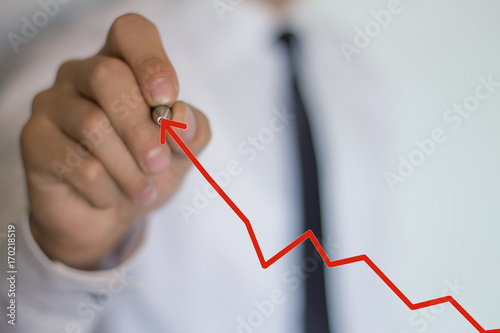 Businessman drawing arrow. Growth concept.