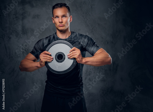 A man holds barbell weight.