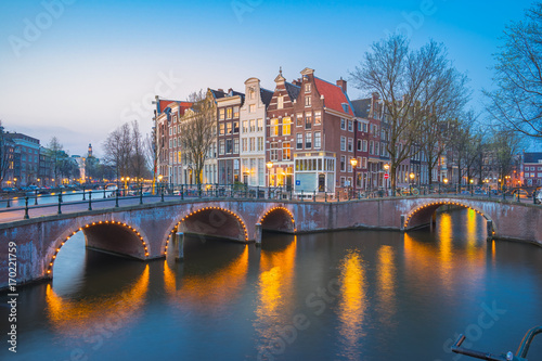 Amsterdam city at night with dutch old buildings in Netherlands