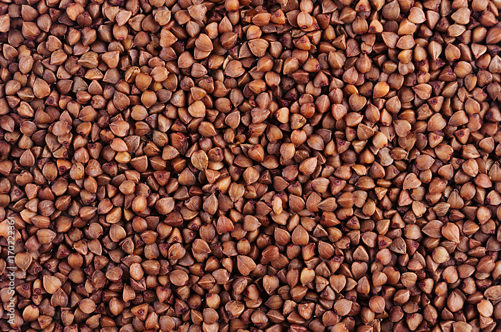 Brown buckwheat background. Top view, closeup. Brown buckwheat background. Top view, closeup.