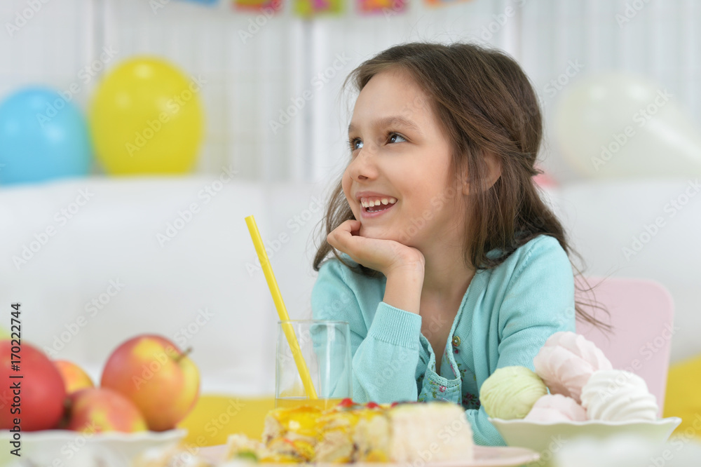 Cute little girl sitting at table Cute little girl sitting at table