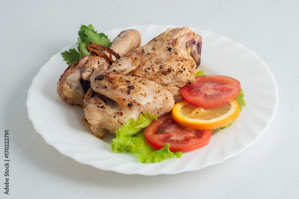 Chicken barbecue kebab on skewer on a white plate Chicken barbecue kebab on skewer on a white plate