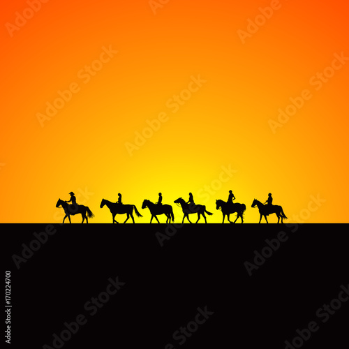 Horse riders silhouettes at sunrise