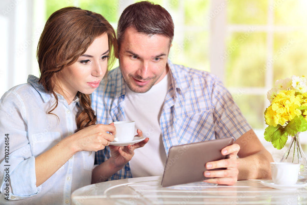 young couple looking at digital tablet young couple looking at digital tablet