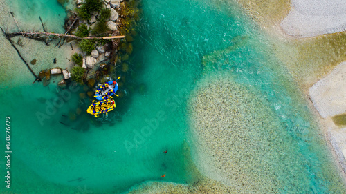 Whitewater Rafting on the Emerald waters of Soca river, Slovenia, are the rafting paradise for adrenaline seekers and also nature lovers, aerial view.