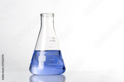Laboratory test glass container with blue liquid test sample.