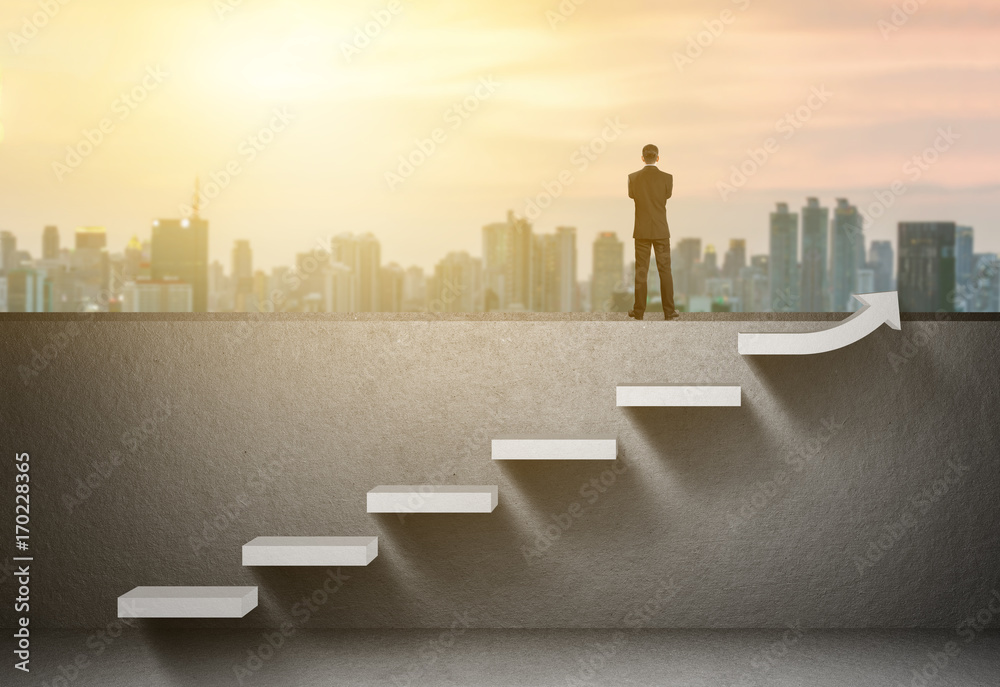 Businessman stand on rising arrow graph on staircase with city sunrise background - obrazy, fototapety, plakaty 