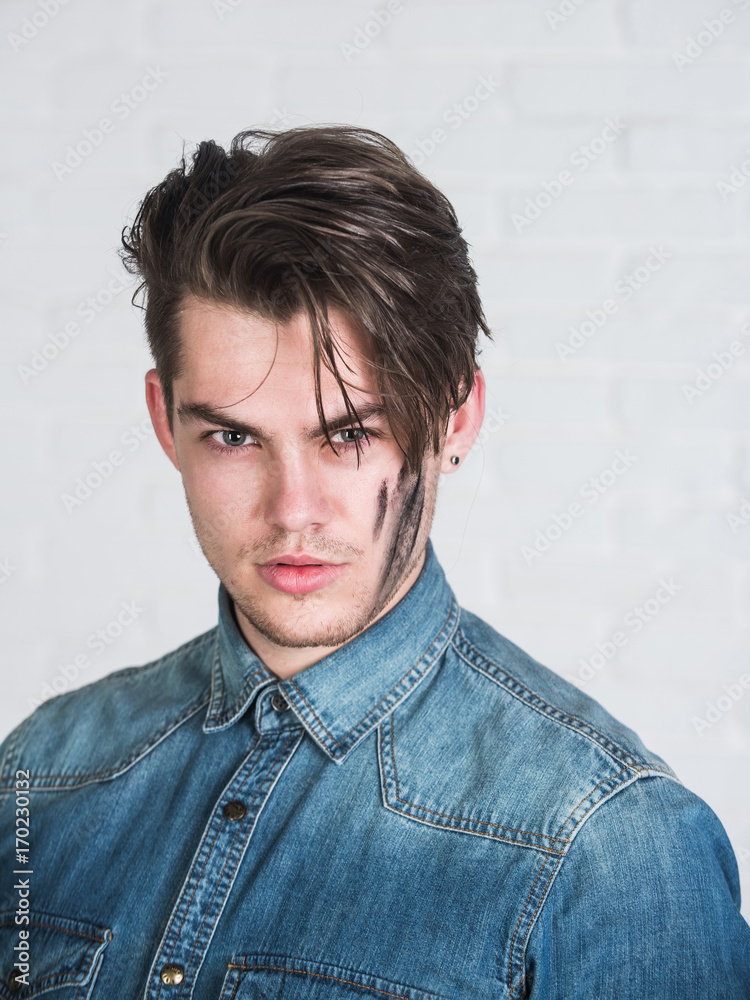 Obraz premium Man posing in blue jean shirt on white background