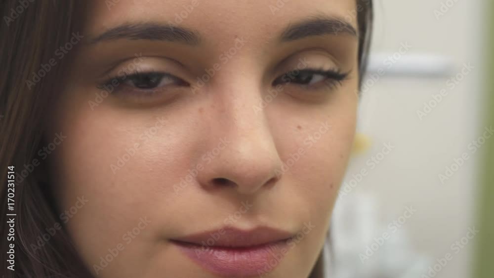 Cute caucasian girl turning her face. Close up of pretty female model with minimal make up. Attractive young woman smiling for the camera Cute caucasian girl turning her face. Close up of pretty female model with minimal make up. Attractive young woman smiling for the camera