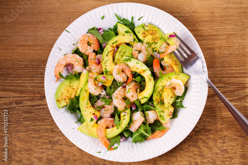 Shrimp salad with avocado and arugula. View from above, top studio shot