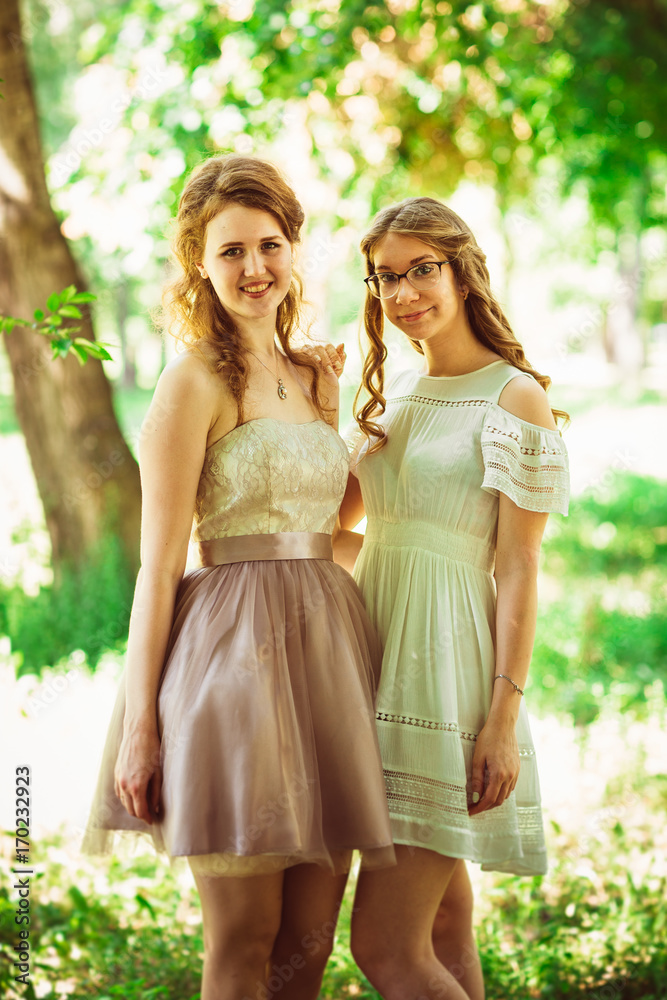 Two beautiful girlfriends on a plant background Two beautiful girlfriends on a plant background