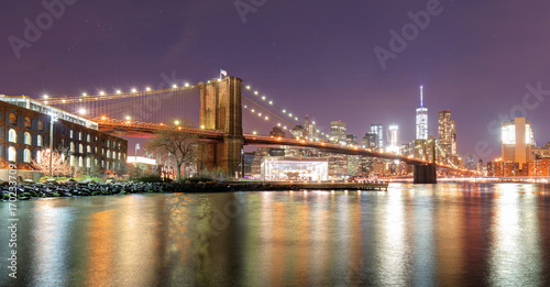 Brooklyn Bridge over East River at night in New York City Manhattan with lights and reflections. © TTstudio