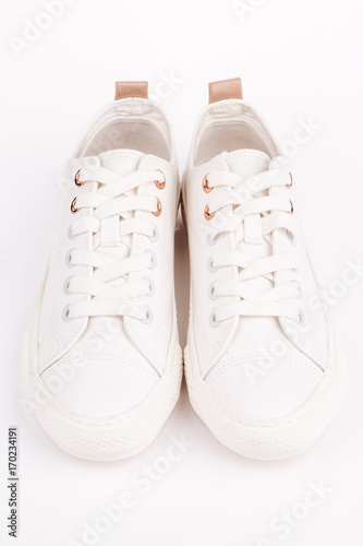 Pair of new white sneakers, isolated on white background