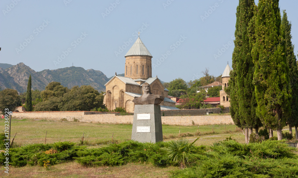 Samtavro Transfiguration Orthodox Church and Nunnery of St. Nino in Mtskheta.The monument to the famous Georgian wrestler, circus performer and movie Sandro Kandelaki. Georgia Samtavro Transfiguration Orthodox Church and Nunnery of St. Nino in Mtskheta.The monument to the famous Georgian wrestler, circus performer and movie Sandro Kandelaki. Georgia