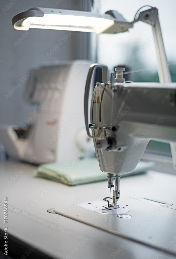 Modern sewing machine at workplace.