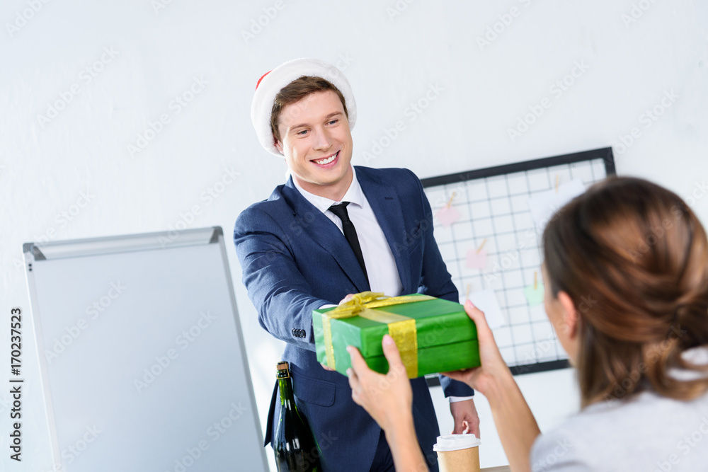 businessman presenting gift to colleague businessman presenting gift to colleague