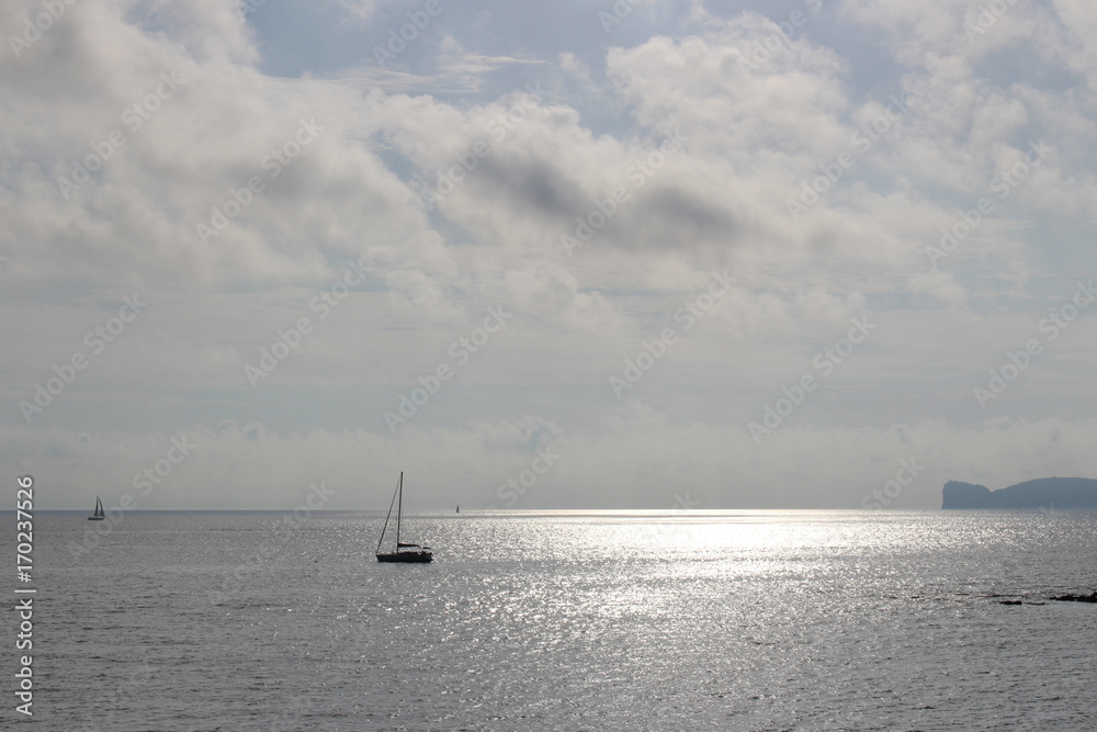 A boat sailing toward the horizon