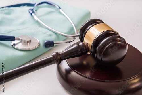 Gavel and stethoscope in background. Medical laws and legal concept. photo