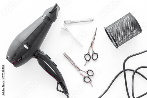 hairdresser work desk with tools for hair styling on white background top view