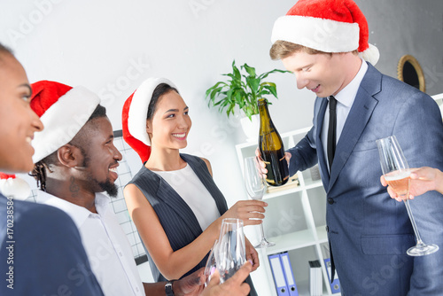 colleagues drinking champagne in office
