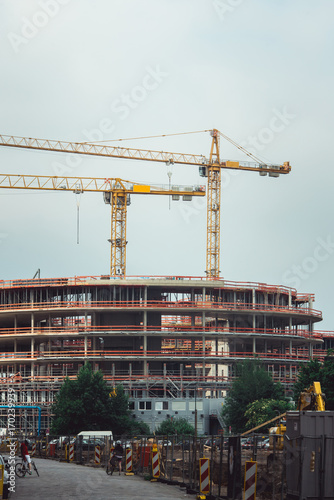 Steel Frames of A Building Under Construction, With Two Tower Cranes On Top. reinforced concrete structures