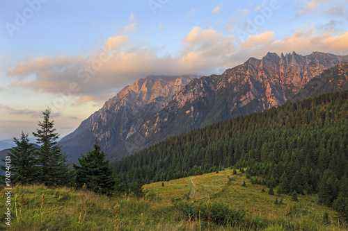 Picturesque view of the mountains under first sunlight. Dramatic morning scene. Carpathians Romania.