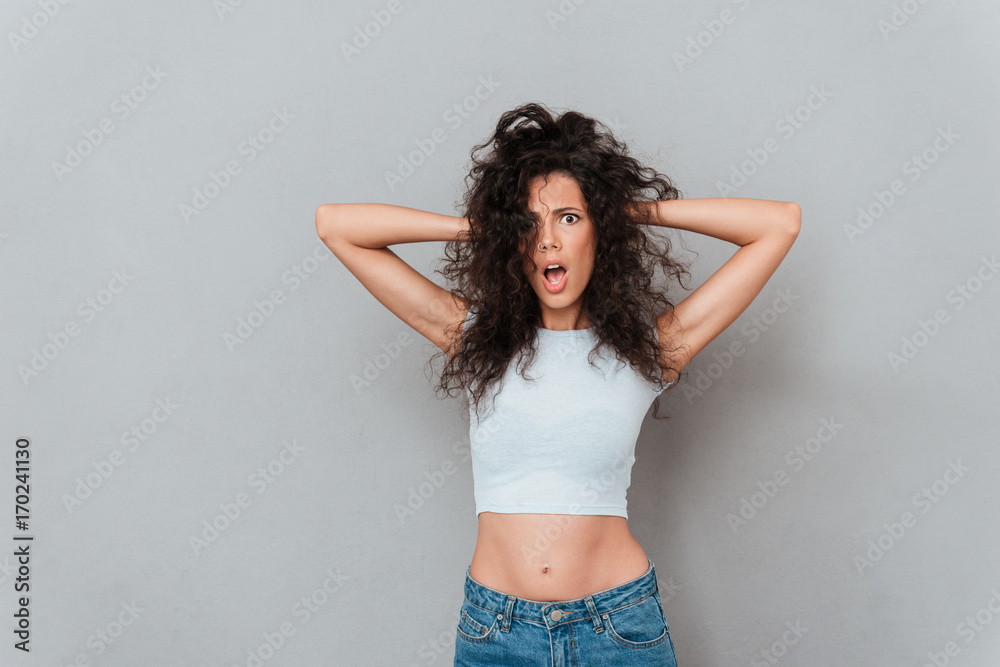 Fototapeta premium Angry displeased woman looking camera with opened mouth